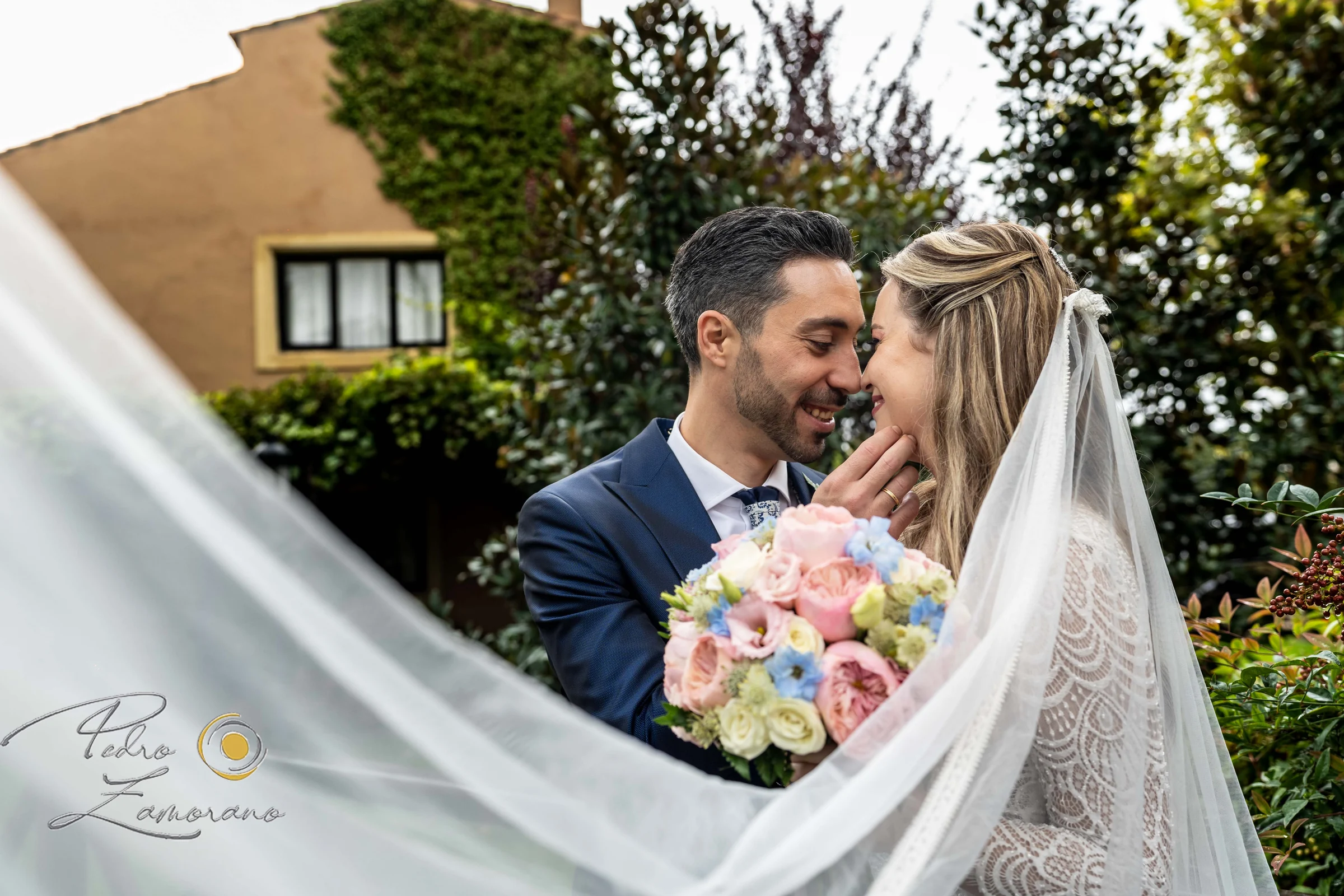 Retrato de los novios entre el velo y los jardines de Finca La Alquería