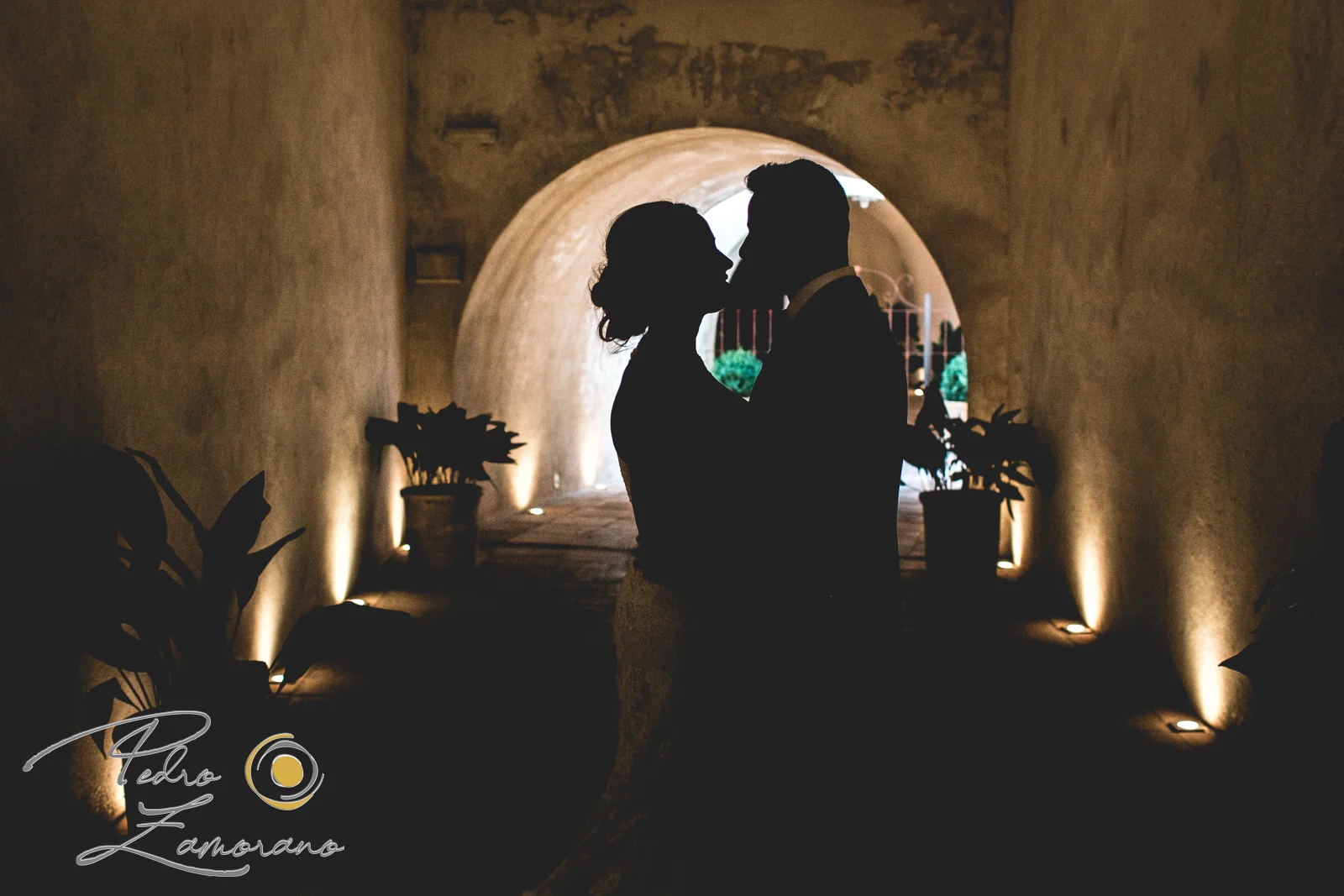 Silueta de los novios en un pasillo iluminado de Finca La Alquería
