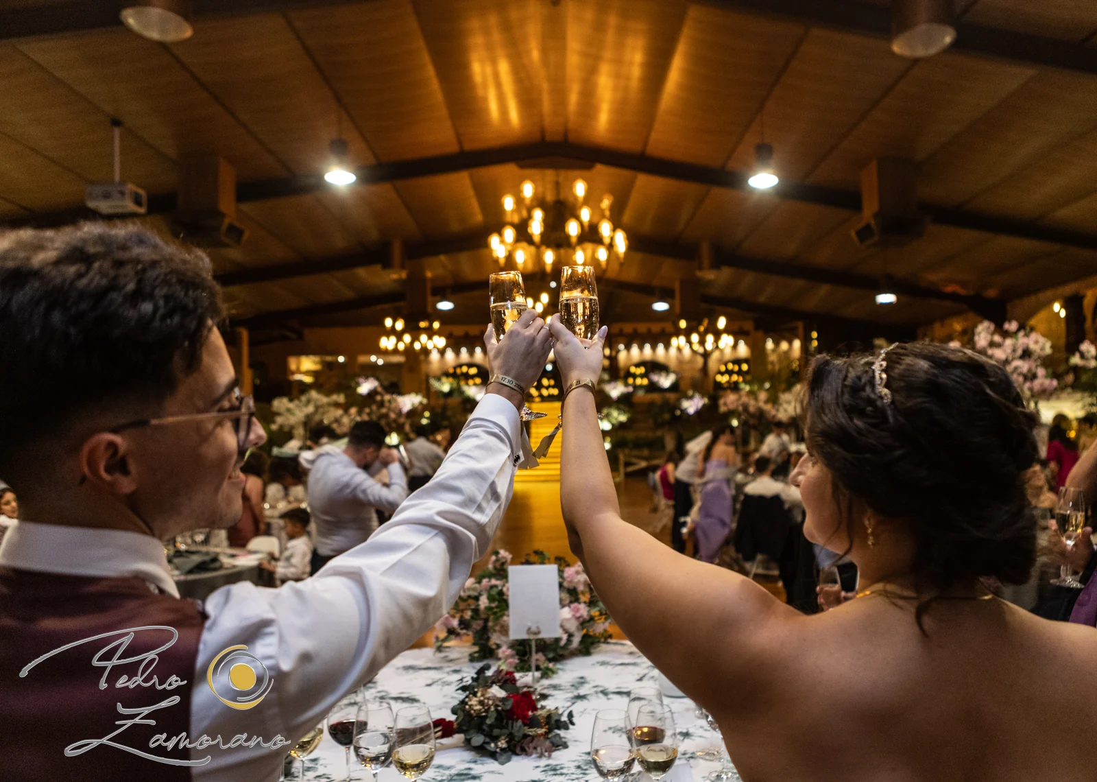 Pareja brindando con copas de champán durante el banquete en Hacienda Jacaranda.