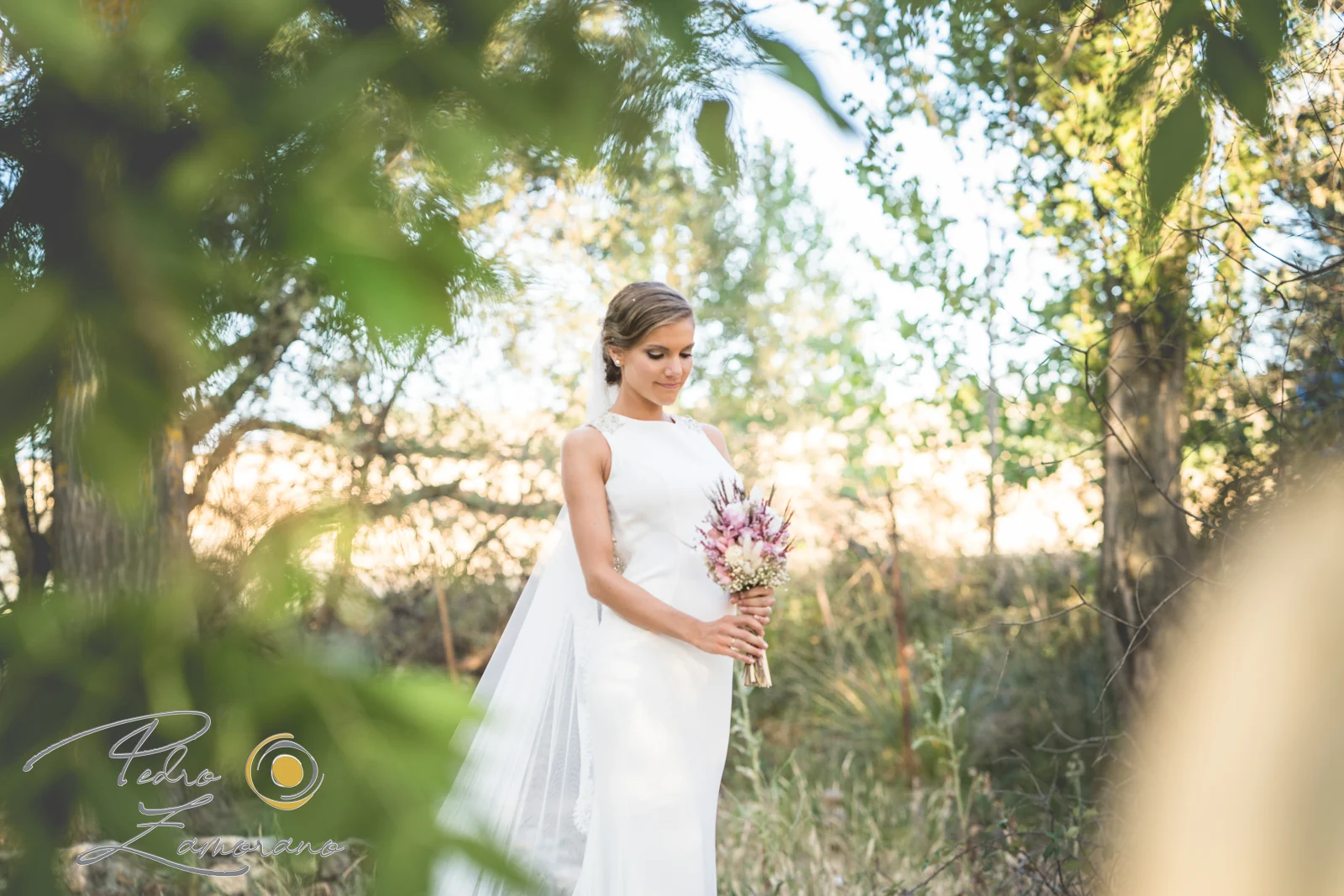 Retrato de novia con ramo entre la vegetación de los jardines de Jardín El Botero.