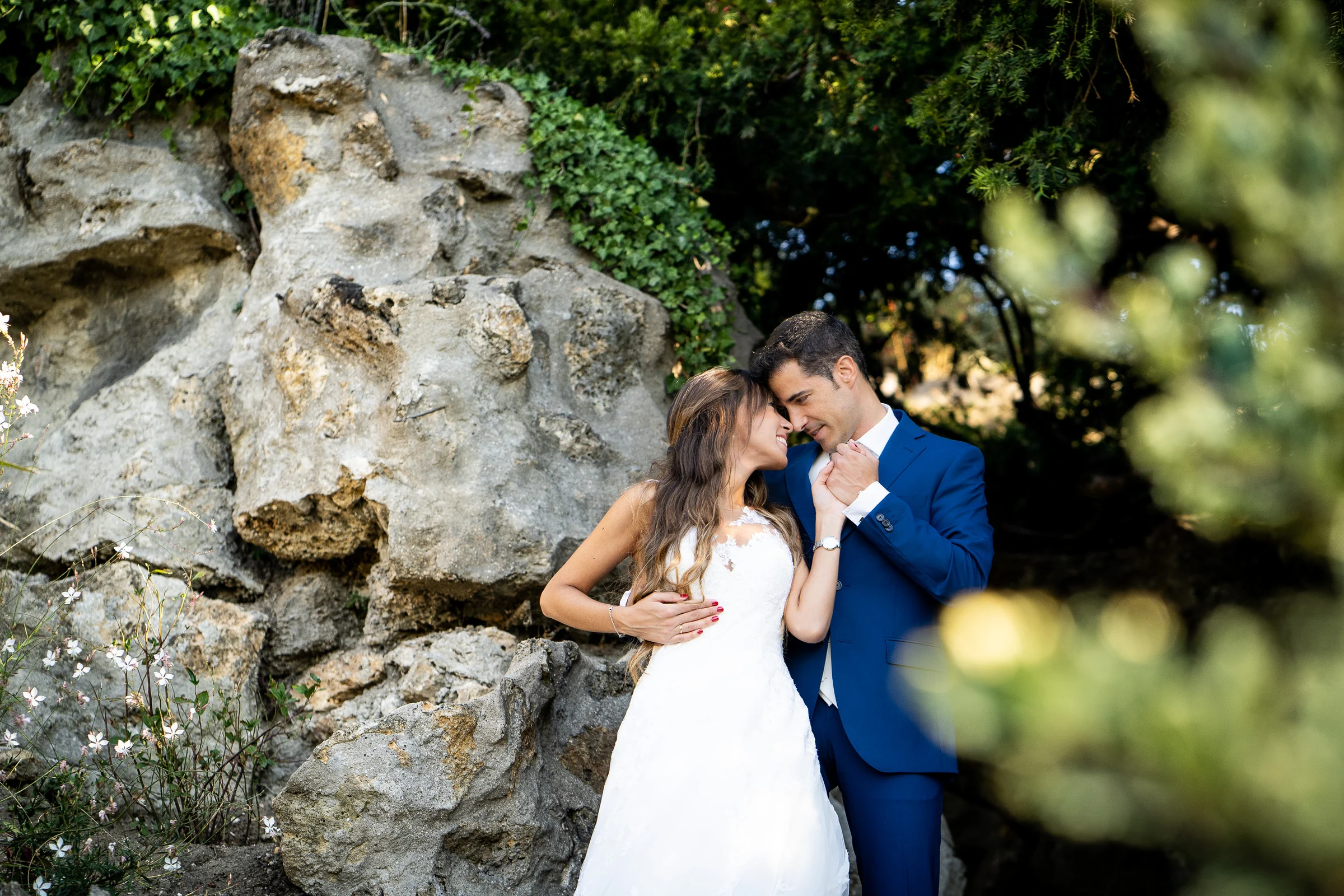 José Luis y Lara se abrazan entre rocas y vegetación durante su postboda en Montmartre.