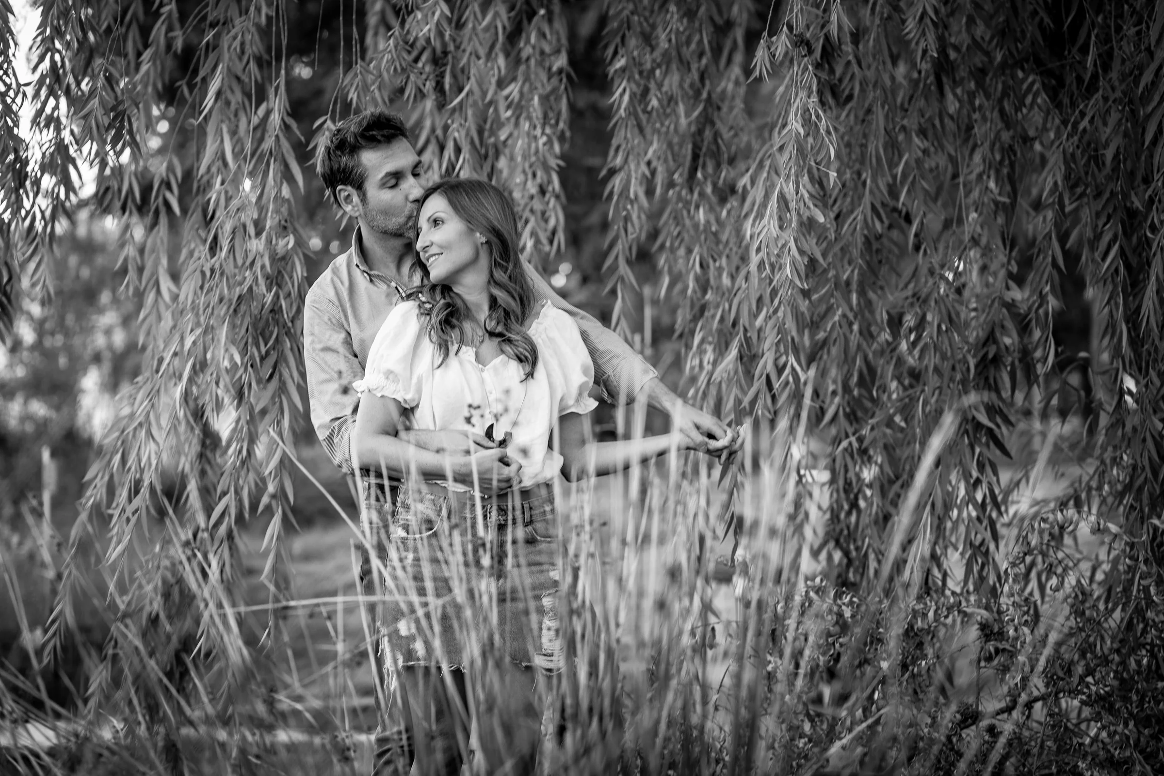 Retrato en blanco y negro de Vanesa y Fran entre la vegetación durante su preboda en Madrid.